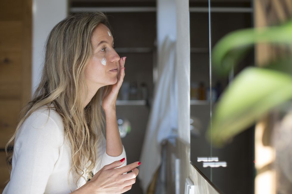 Woman applying face cream