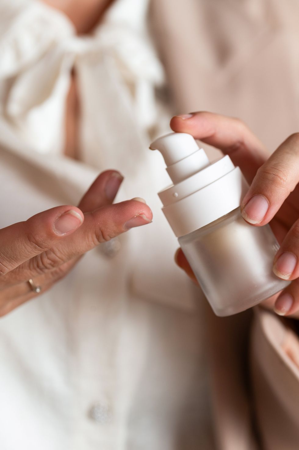 Woman applying foundation moisturiser