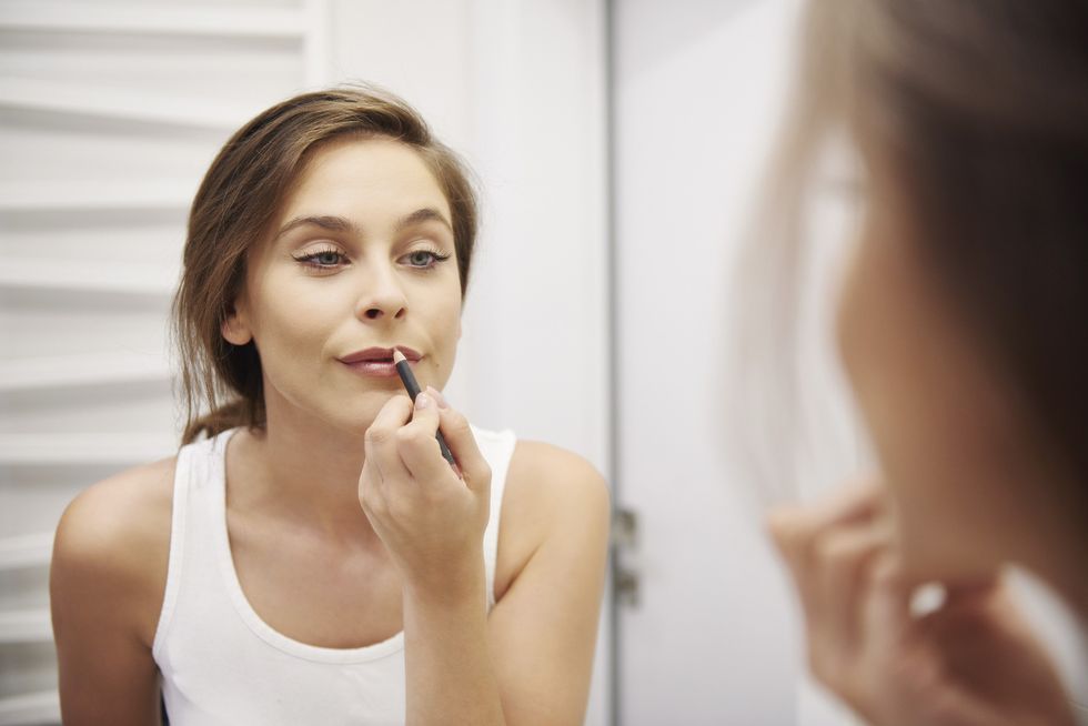 Woman applying lip liner