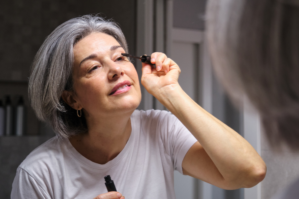 Woman applying mascara