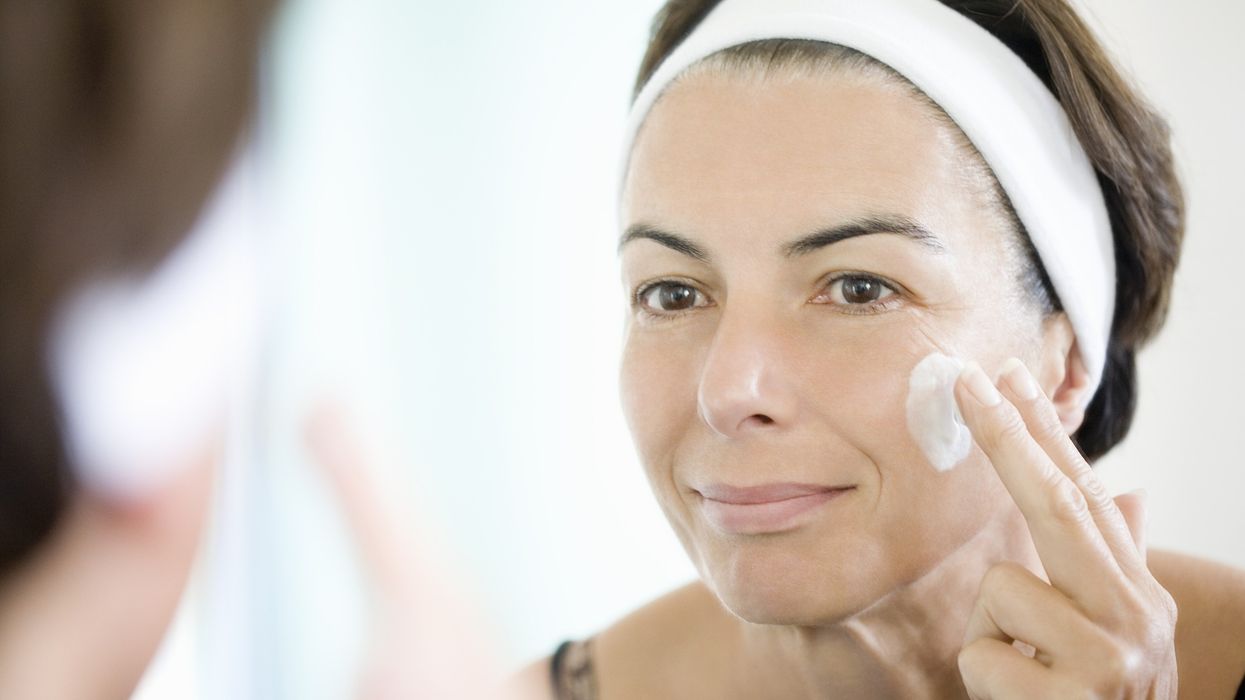 Woman applying skin care cream