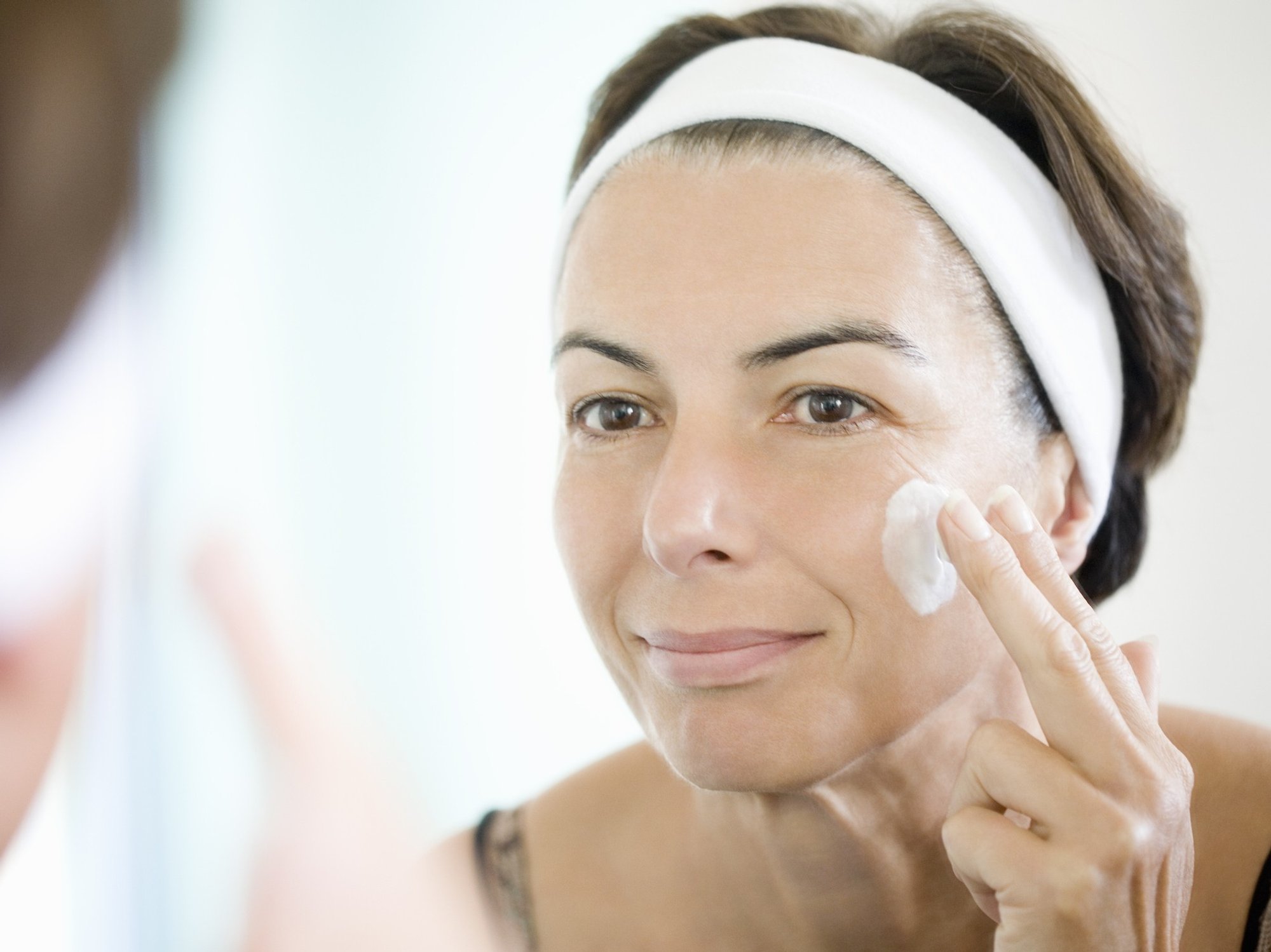 Woman applying skin care