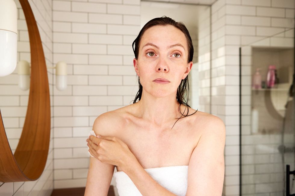 WOMAN APPLYING SKIN CARE