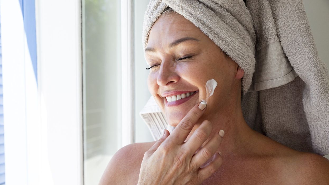 Woman applying sunscreen to her face