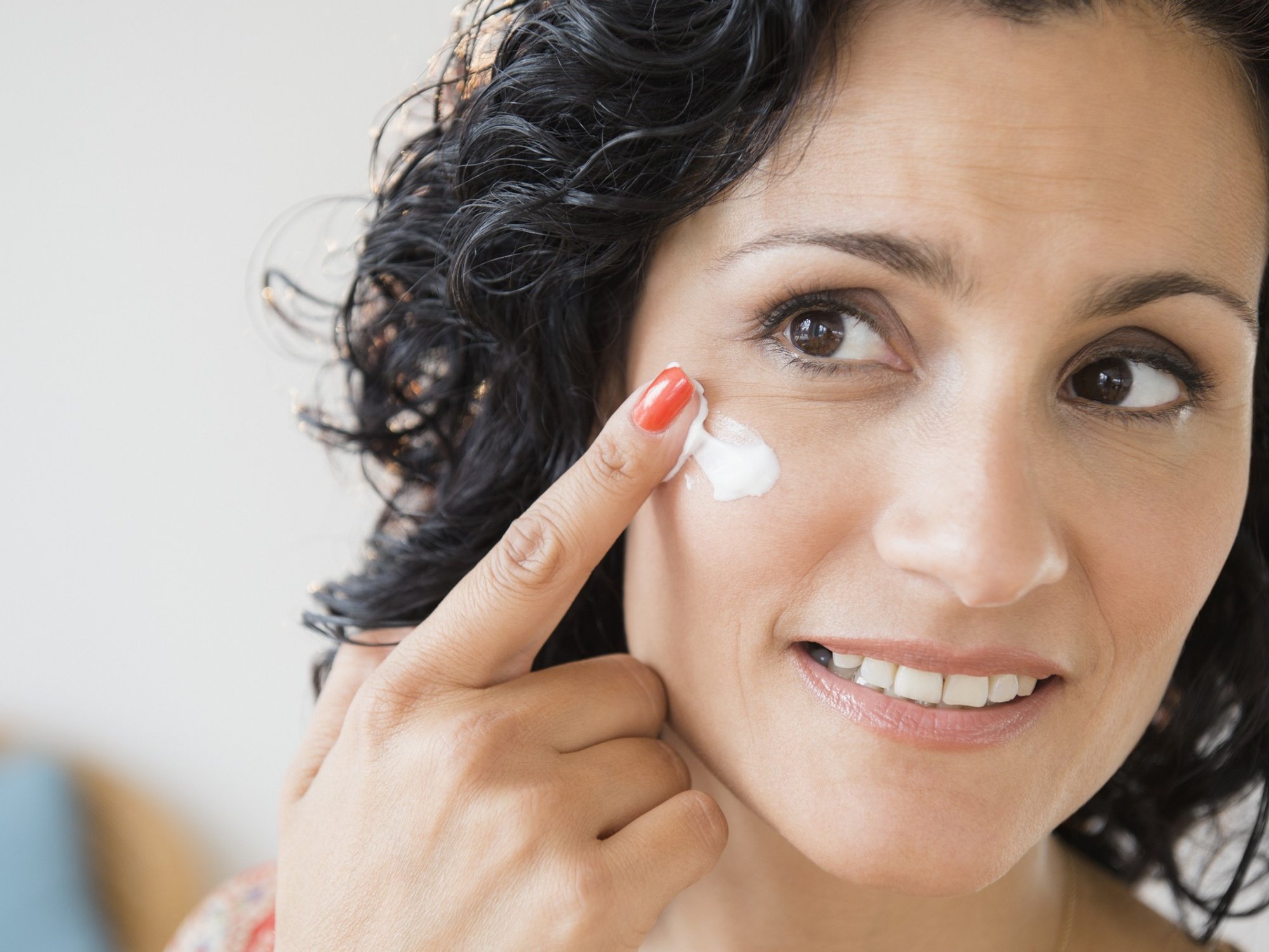 Woman applying sunscreen