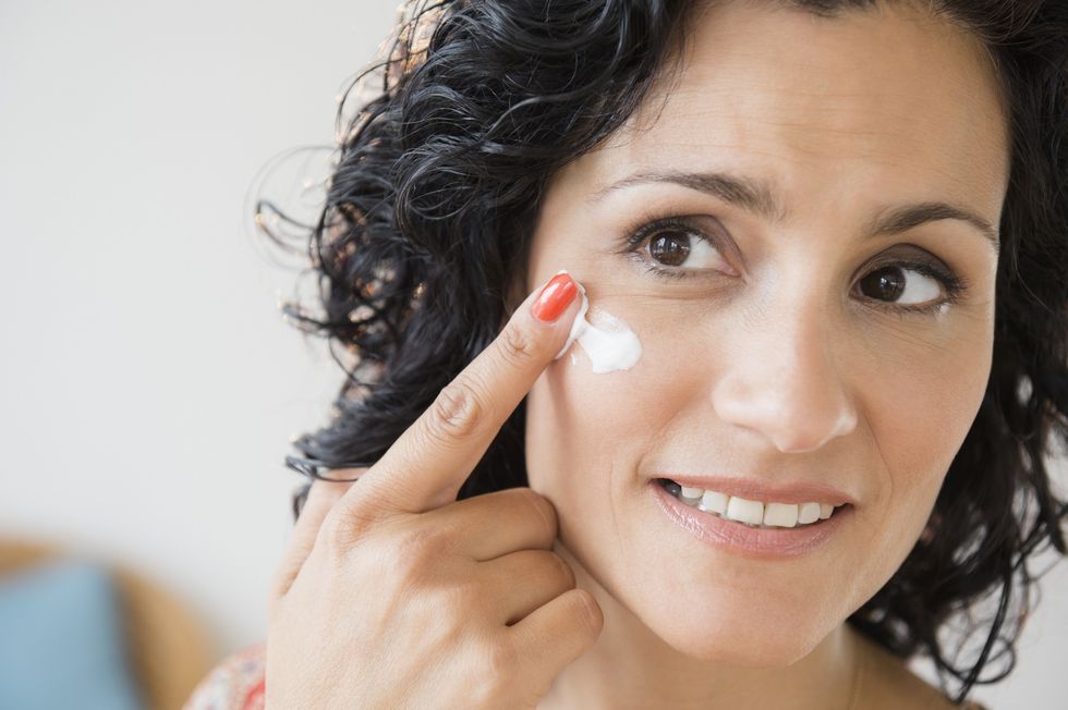Woman applying sunscreen
