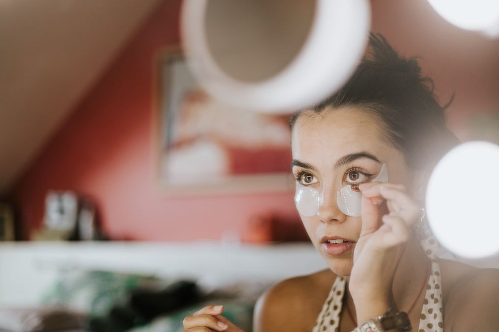 Woman applying under-eye patches