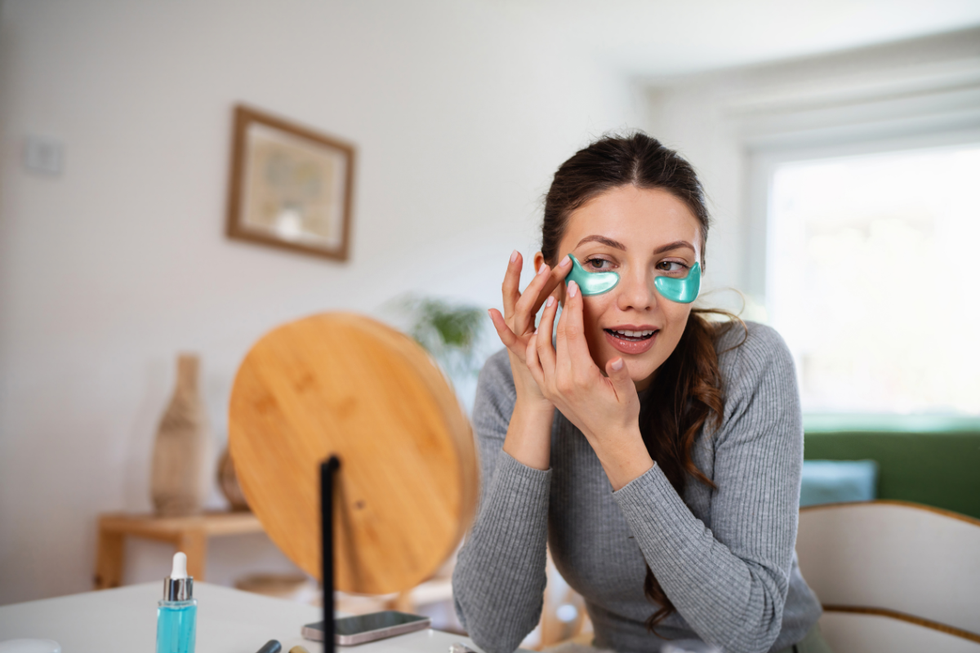 Woman applying under-eye sheets