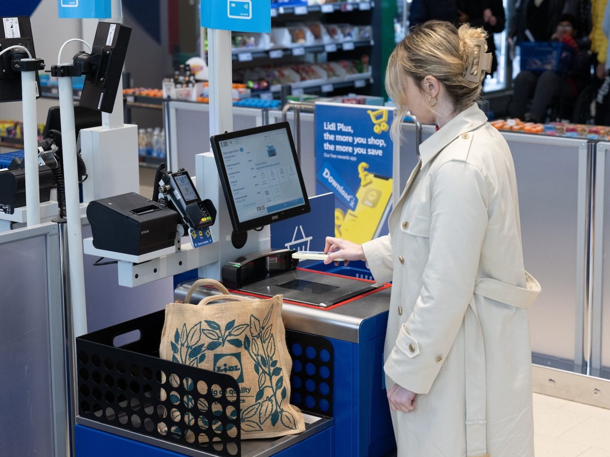 Woman at a Lidl self-checkout