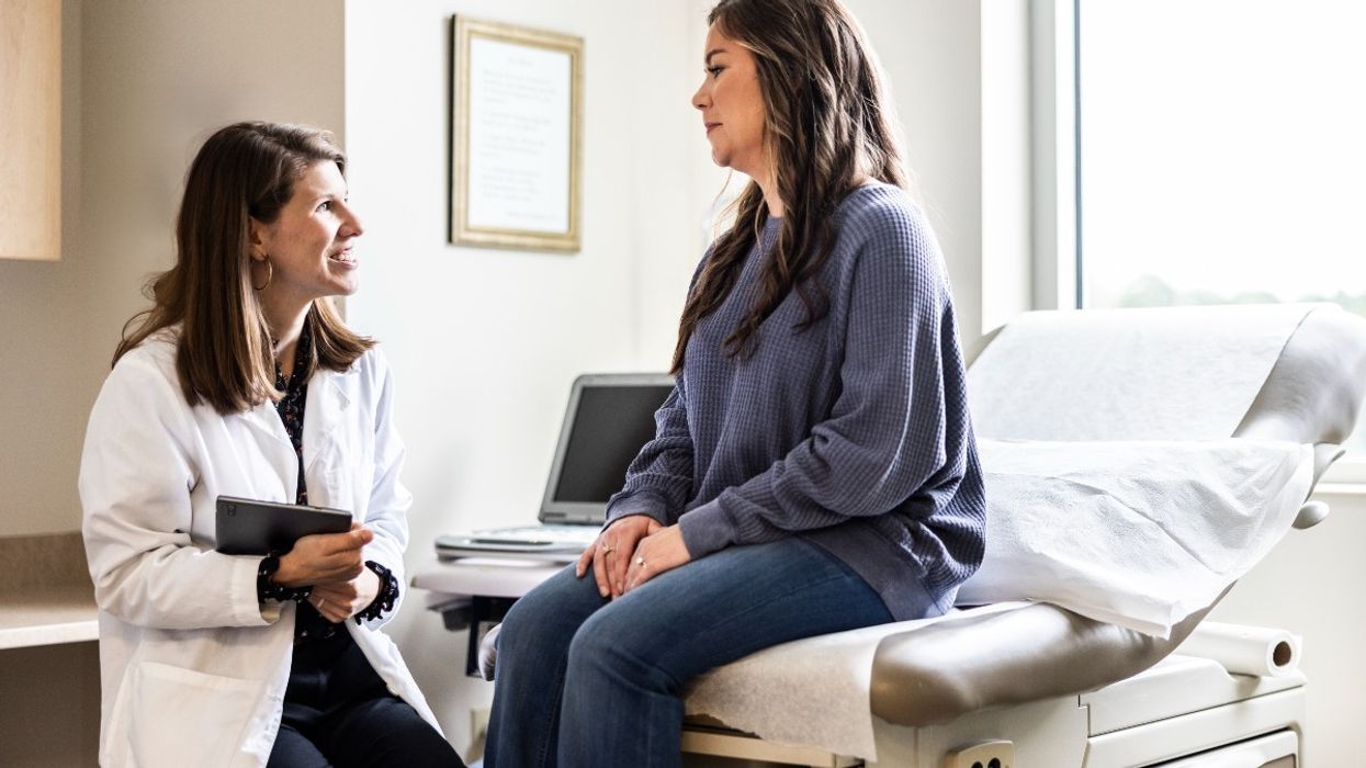 Woman being spoken to by a female doctor