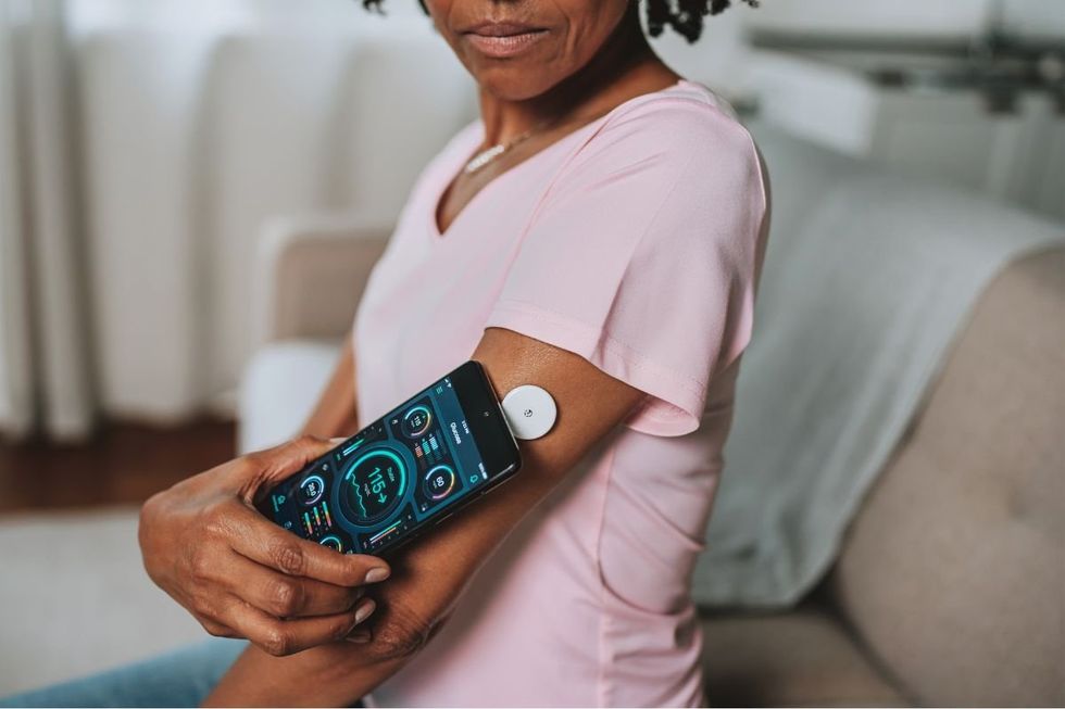 WOMAN BLOOD GLUCOSE MONITOR