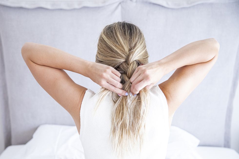 Woman braiding her hair