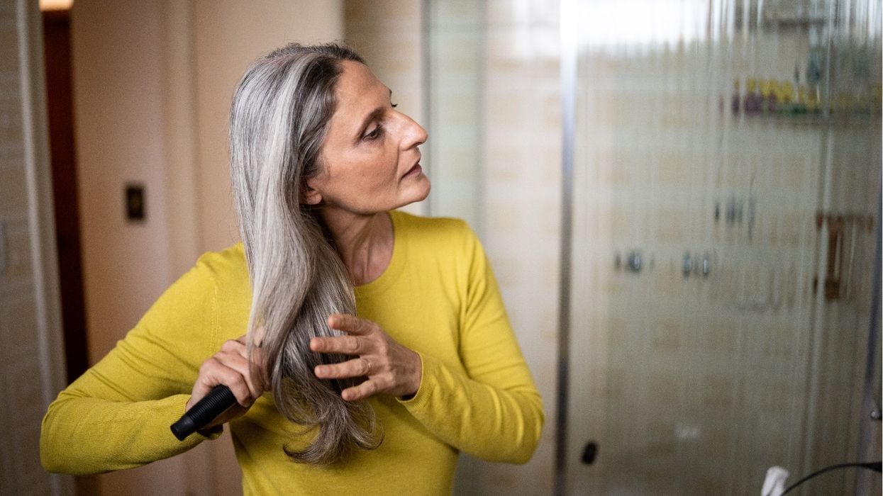 WOMAN BRUSHING HAIR