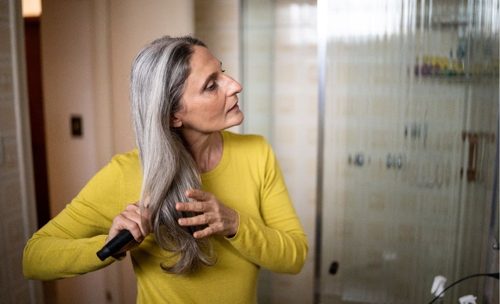 WOMAN BRUSHING HAIR