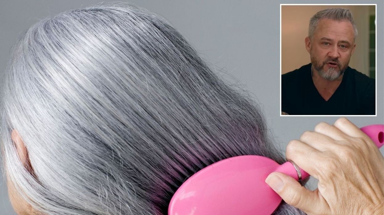Woman brushing her hair / Justin Hickox