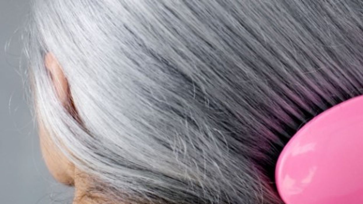 WOMAN BRUSHING LONG HAIR