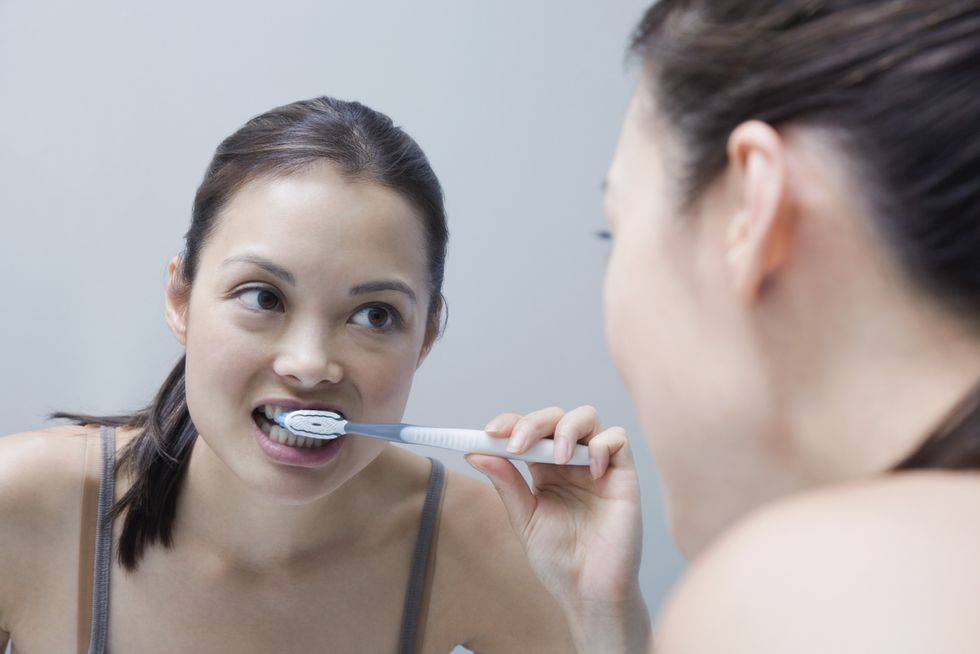 woman brushing teeth