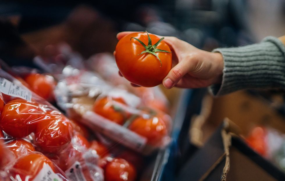 Woman buying a tomato