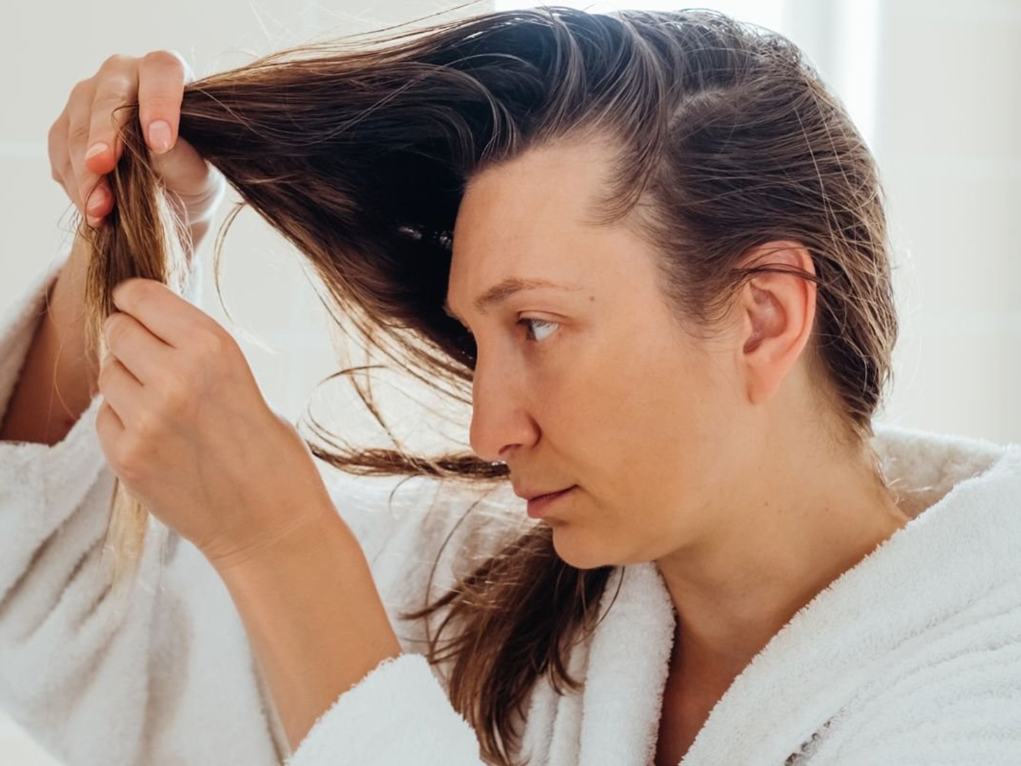 WOMAN CHECKING HAIR COLOUR