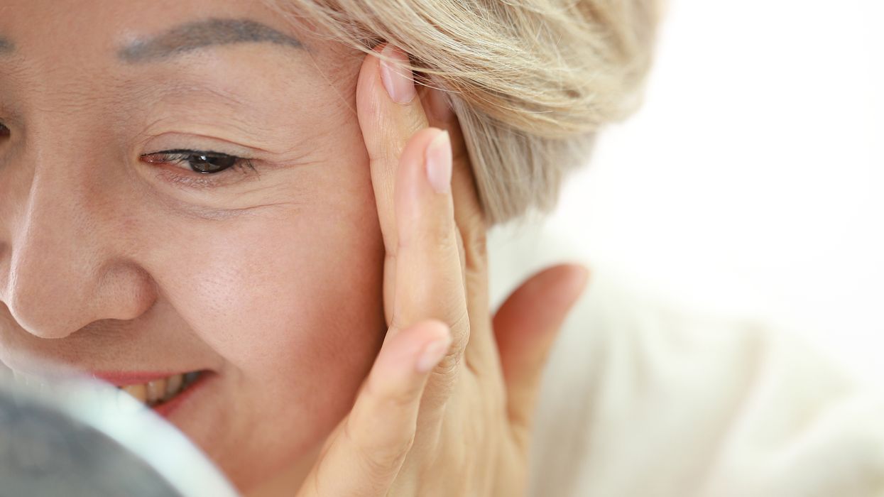 woman checking lines around eyes