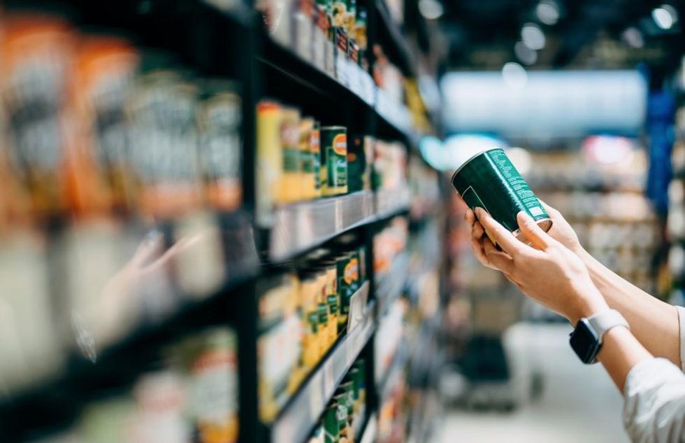 WOMAN CHECKING PRODUCT LABEL