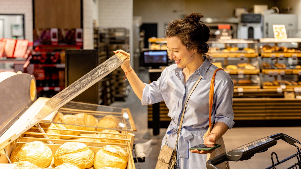Woman choosing bread in a supermarket