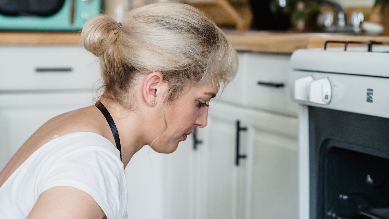 Woman cleaning oven