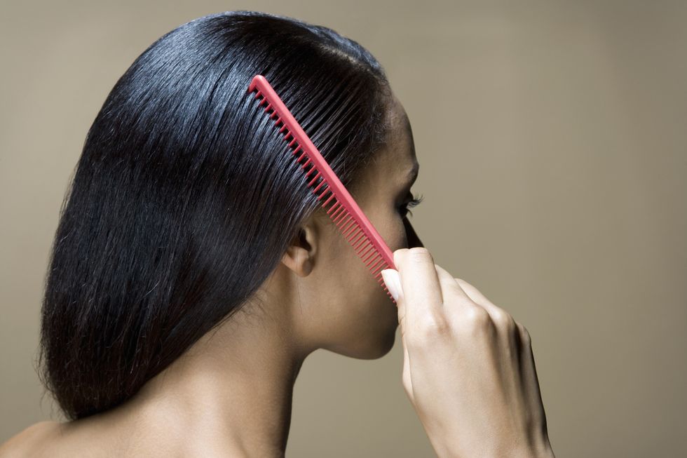 Woman combing hair