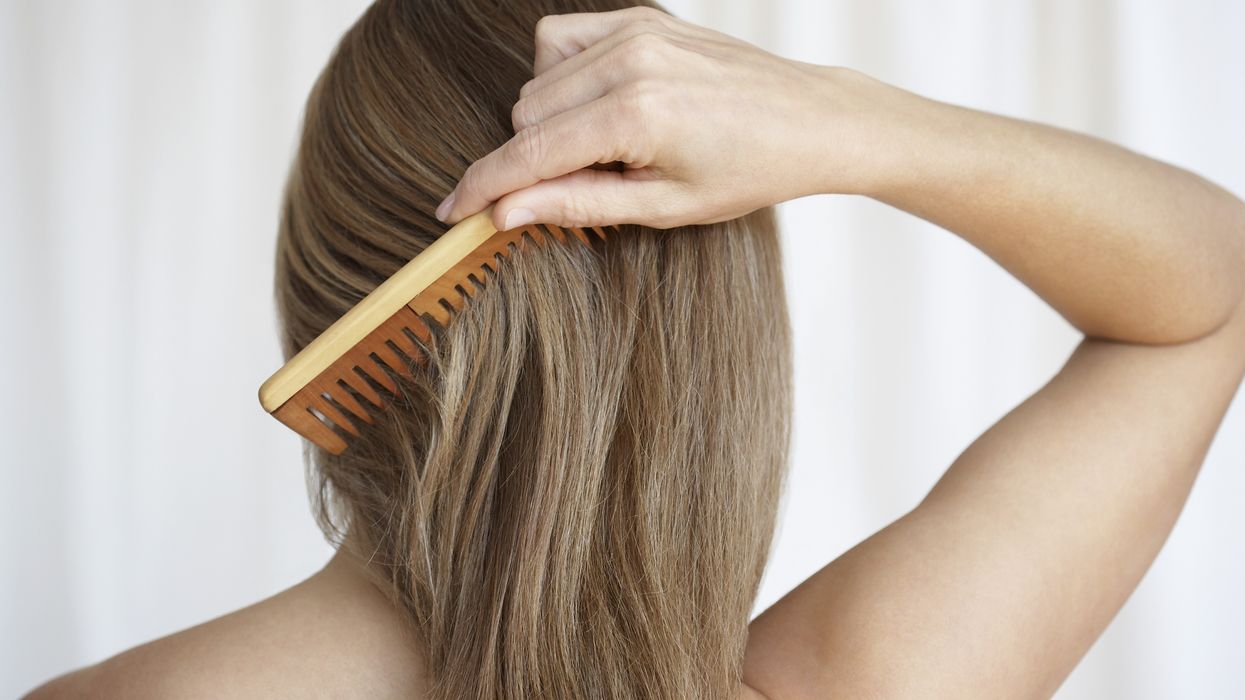 woman combing her hair