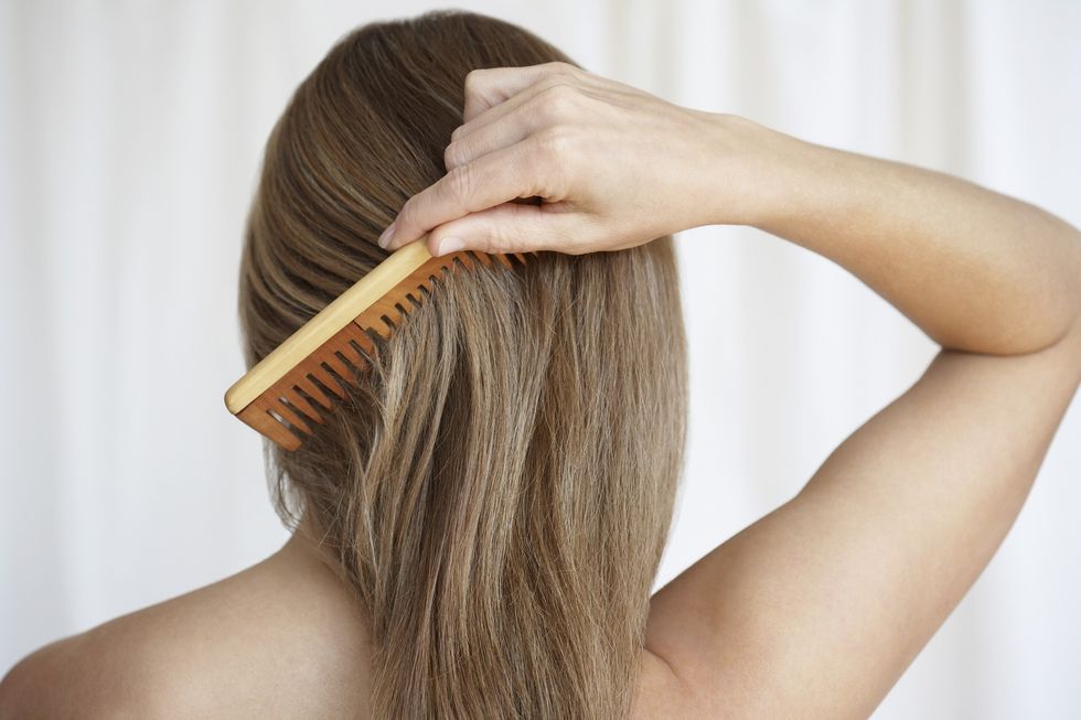 Woman combing her hair