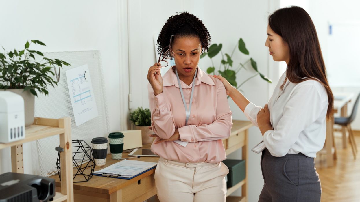 Woman consoling another woman at work