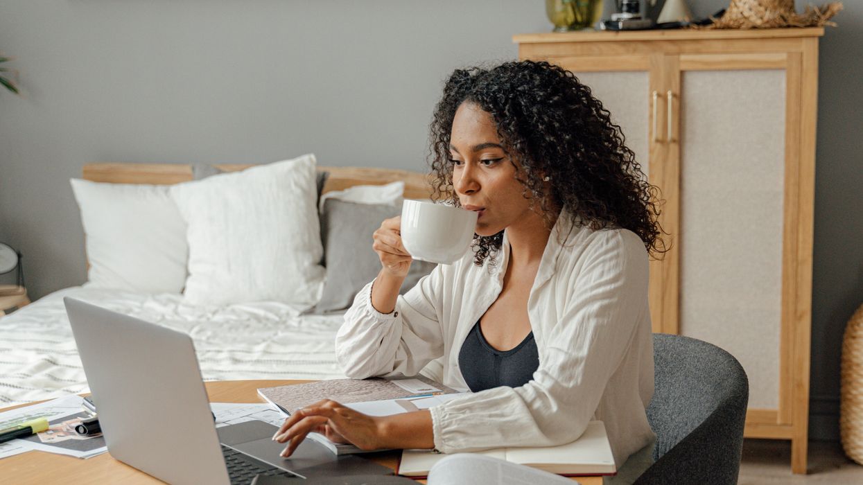 Woman drinking coffee at desk