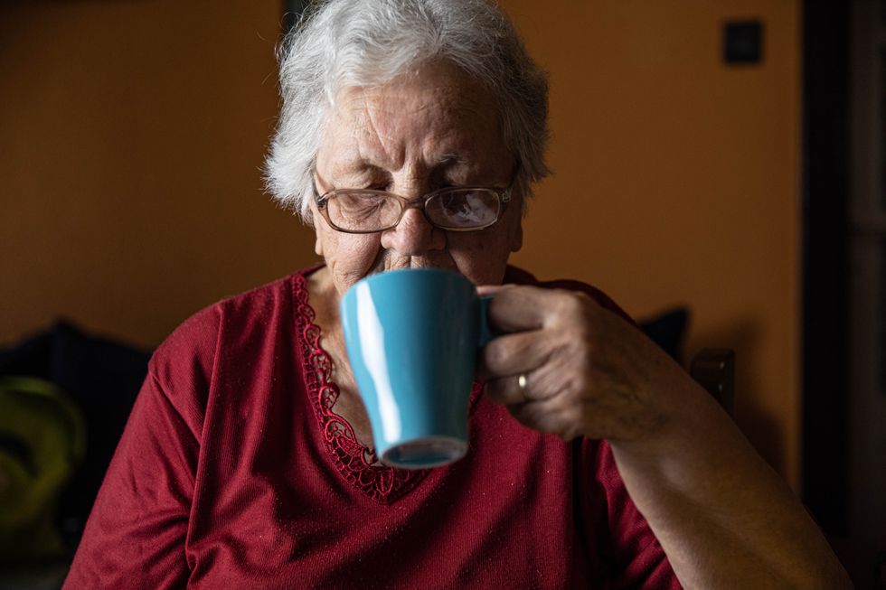 WOMAN DRINKING FROM CUP