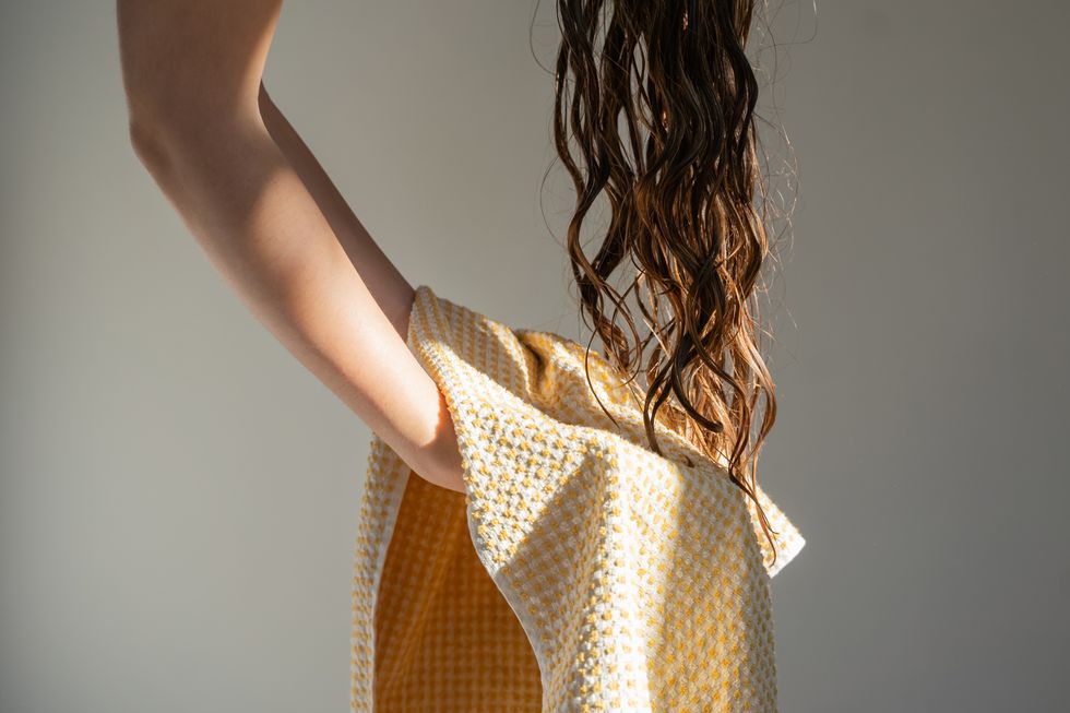 WOMAN DRYING HAIR