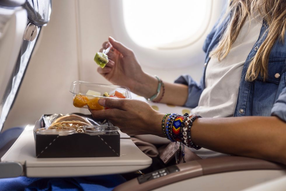 Woman eating a meal during a flight