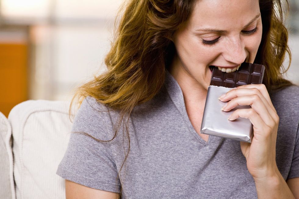 Woman eating chocolate bar
