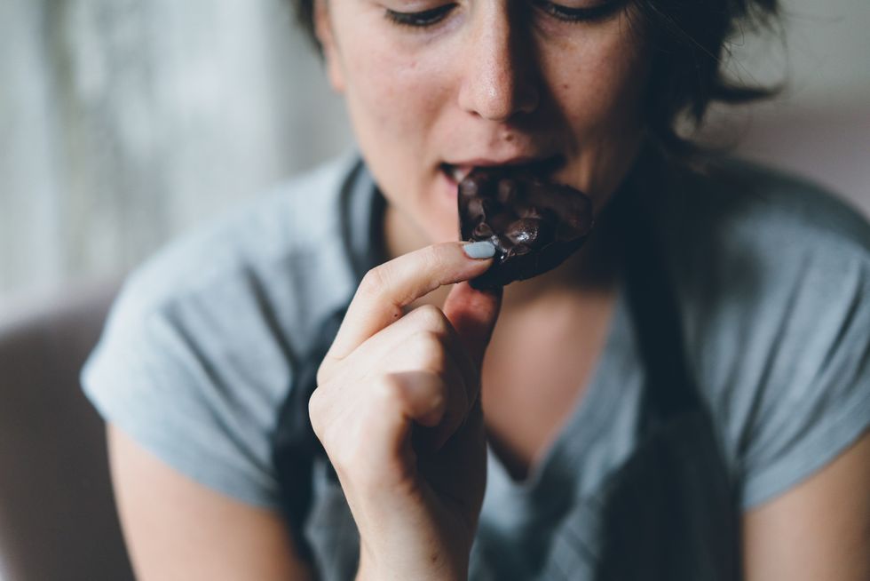 Woman eating dark chocolate