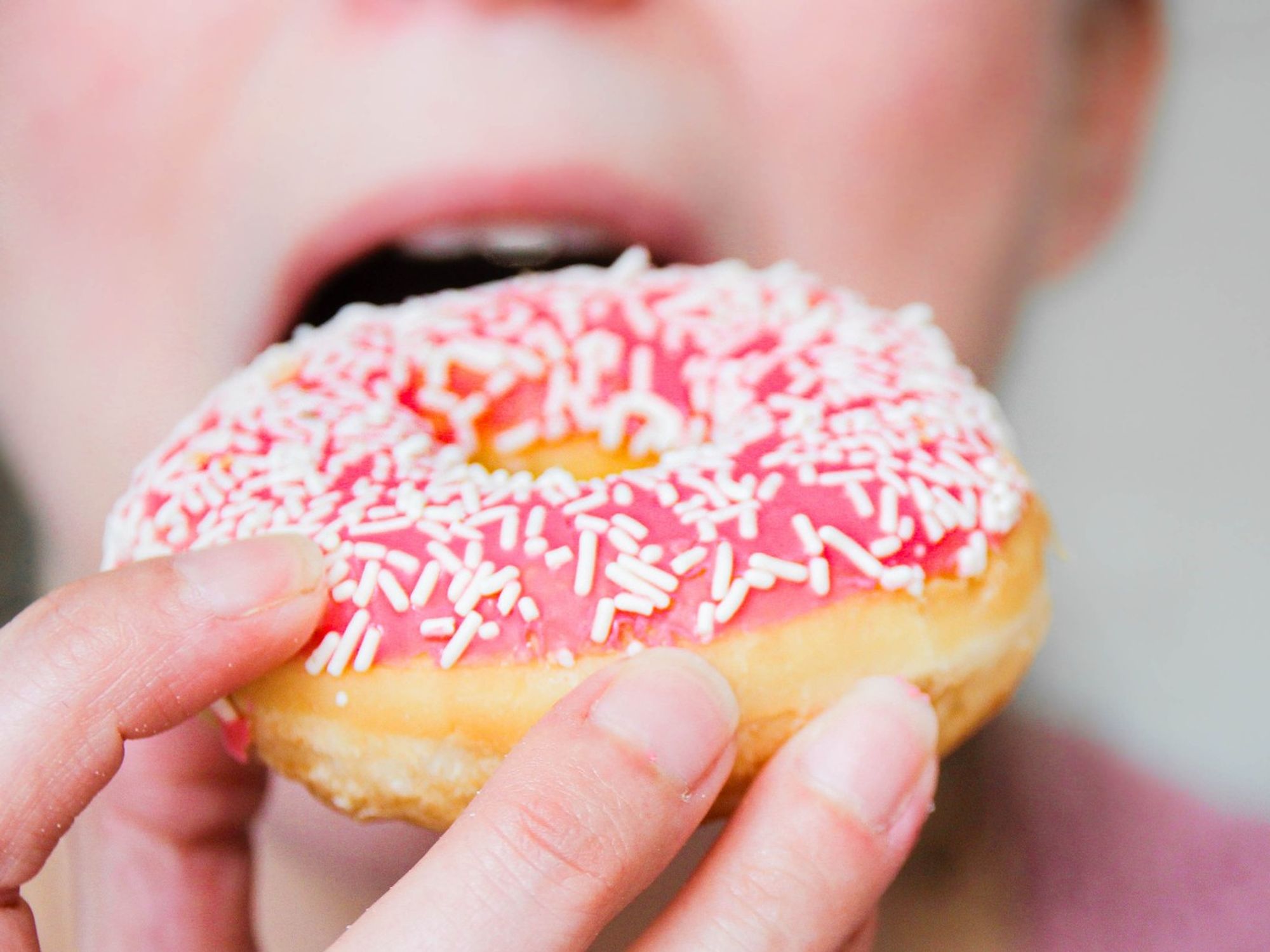 Woman eating doughnuts
