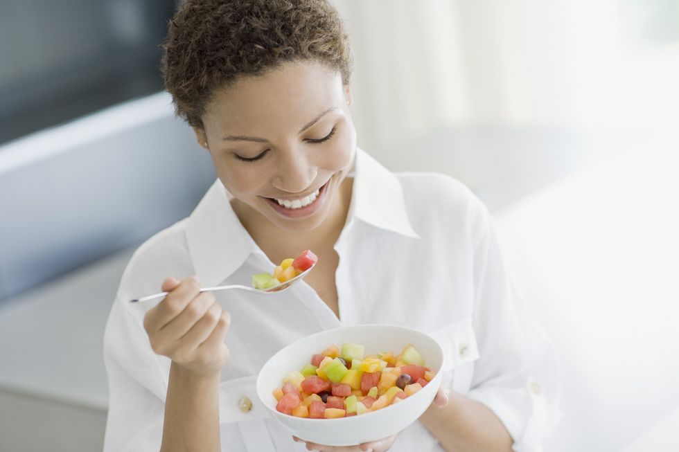 Woman eating fruit salad