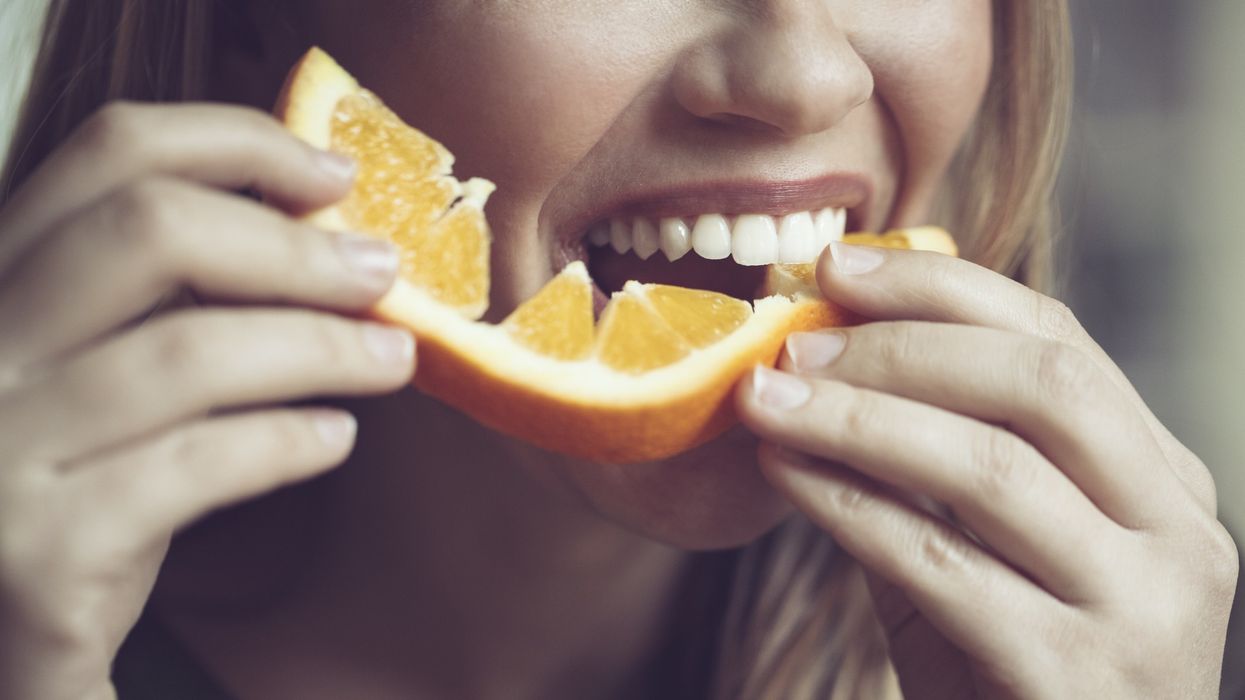 Woman eating orange