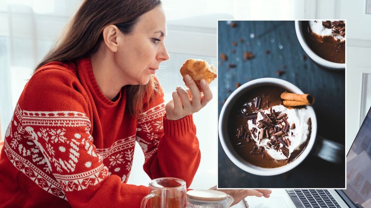 woman eating pastry and hot chocolate stock image