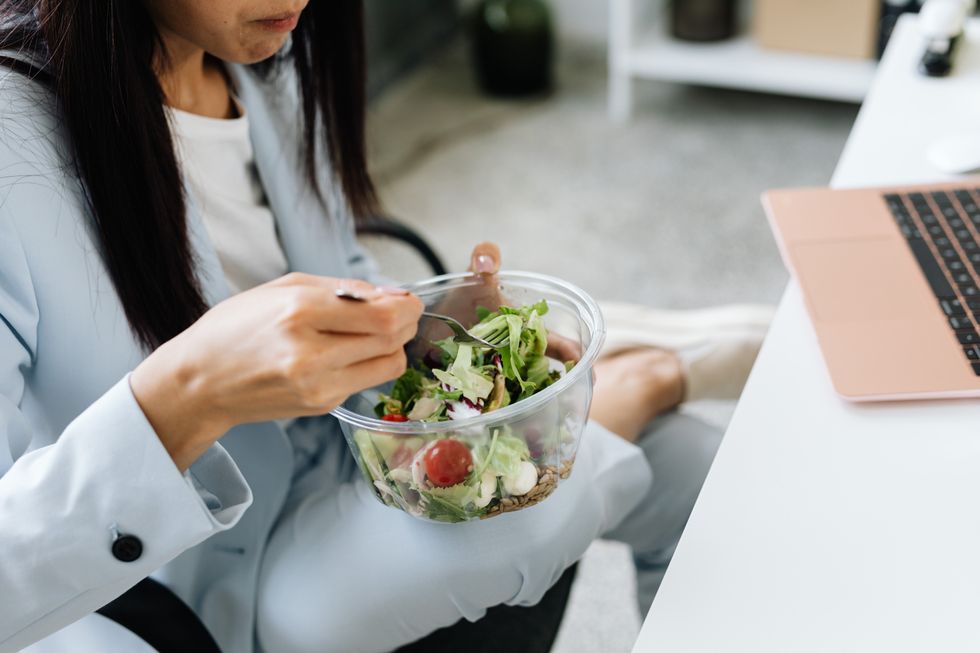 WOMAN EATING SALAD