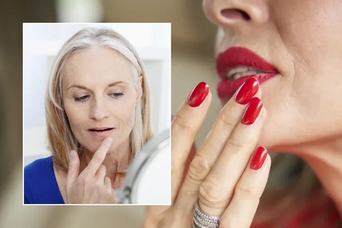 Woman examining her lips in mirror / Woman wearing matte red lipstick