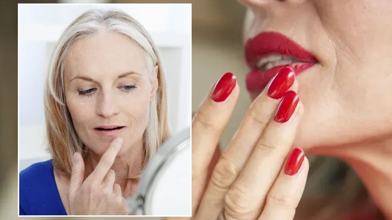 Woman examining her lips in mirror / Woman wearing matte red lipstick