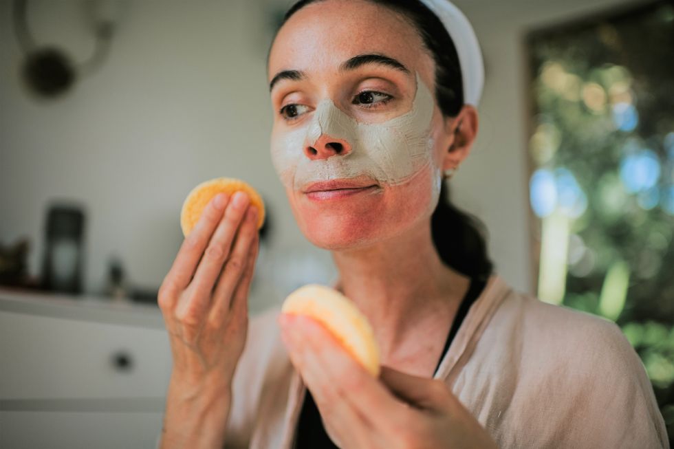 Woman exfoliating face