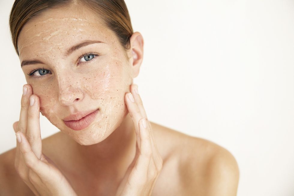 Woman exfoliating her face