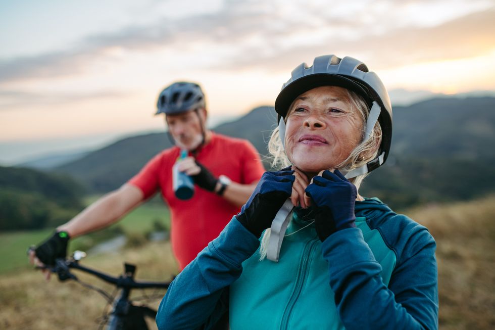 woman fastening helmet