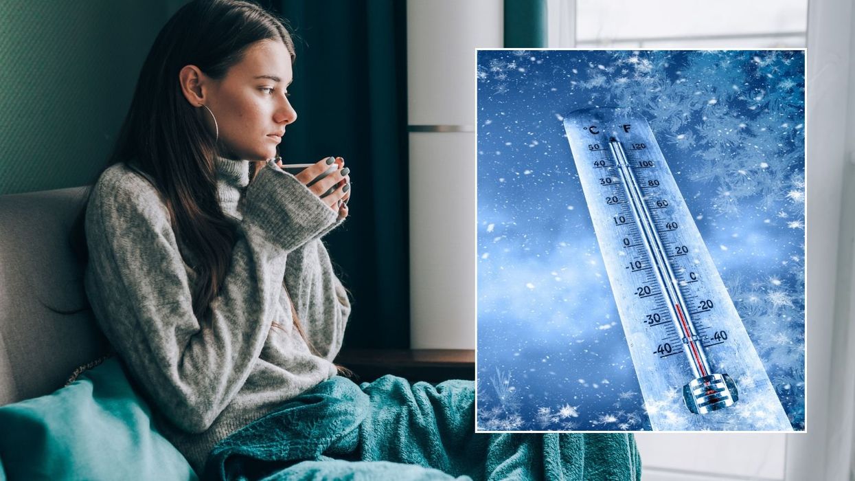 Woman feeling cold at home and icy thermometer