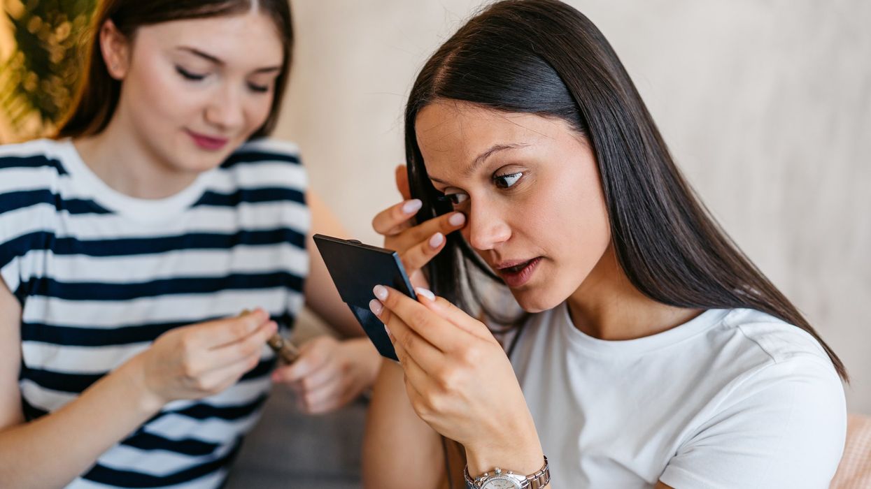 Woman fixing her smudged mascara