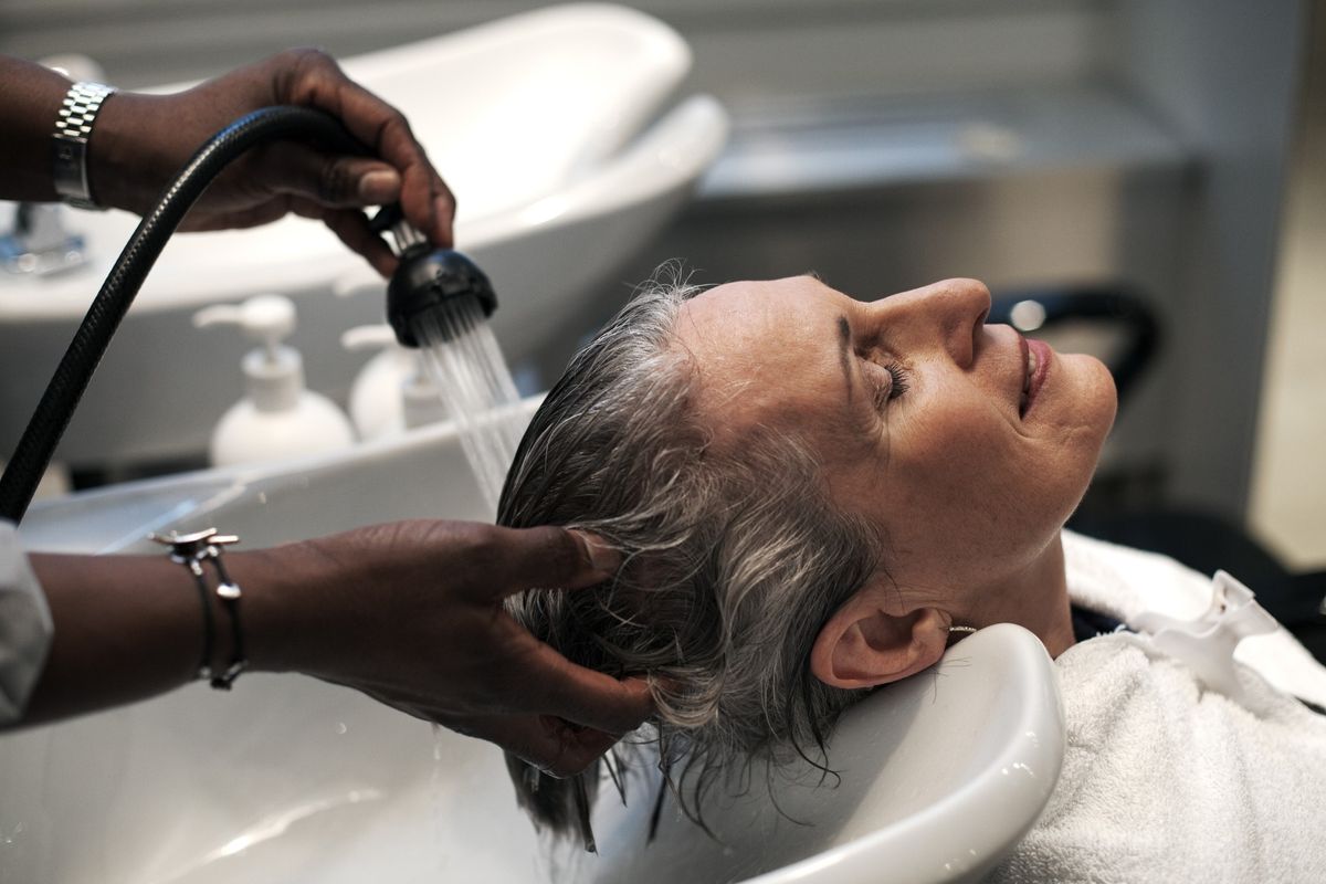 Woman getting her grey hair washed